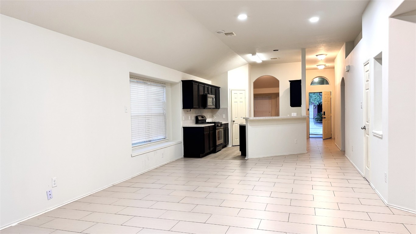 6818 Hampden Point Court Houston, TX 77040 - Photo 7 of 17 a view of a kitchen with an empty room and a kitchen