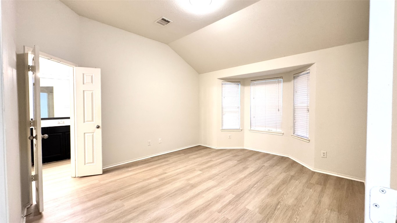 6818 Hampden Point Court Houston, TX 77040 - Photo 9 of 17 an empty room with windows and closet
