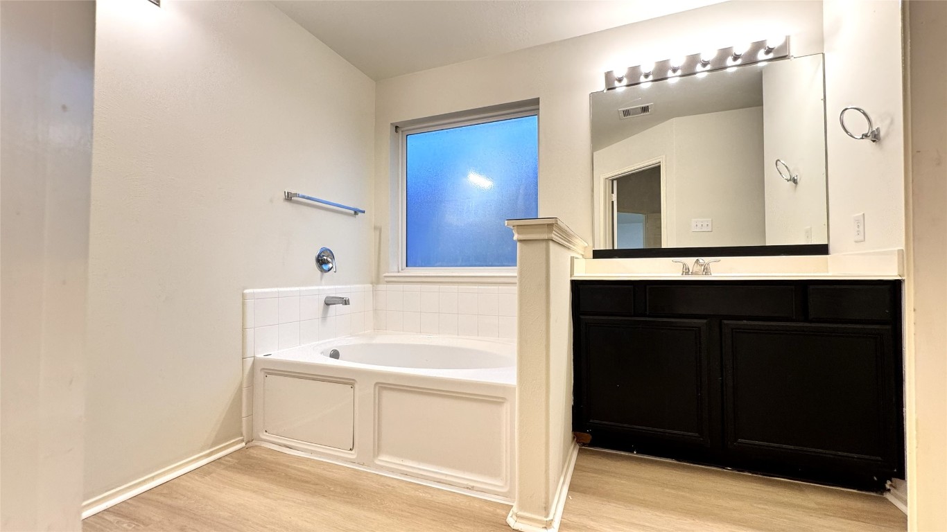 6818 Hampden Point Court Houston, TX 77040 - Photo 10 of 17 a bathroom with a sink and a mirror