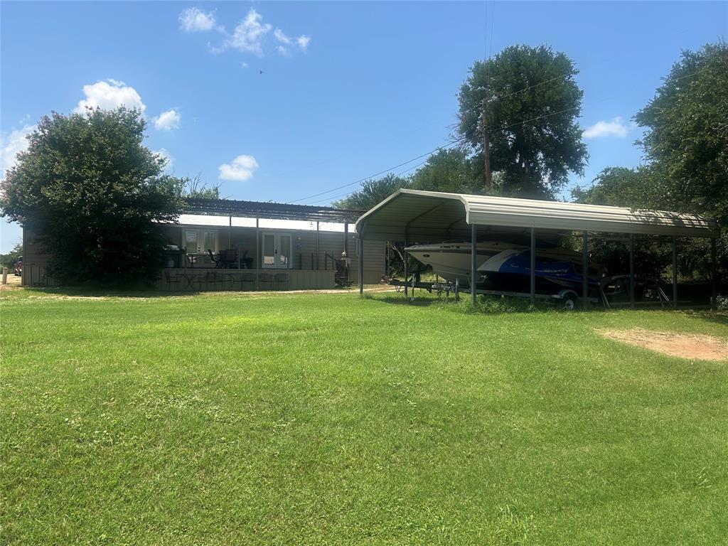 a view of a house with a backyard and a patio