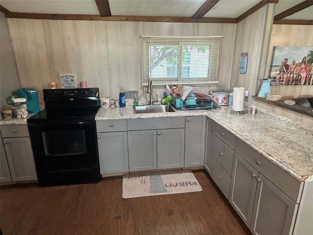 4705 Fox Hollow Road Graham, TX 76450 - Photo 12 of 28 a kitchen with a sink cabinets and window