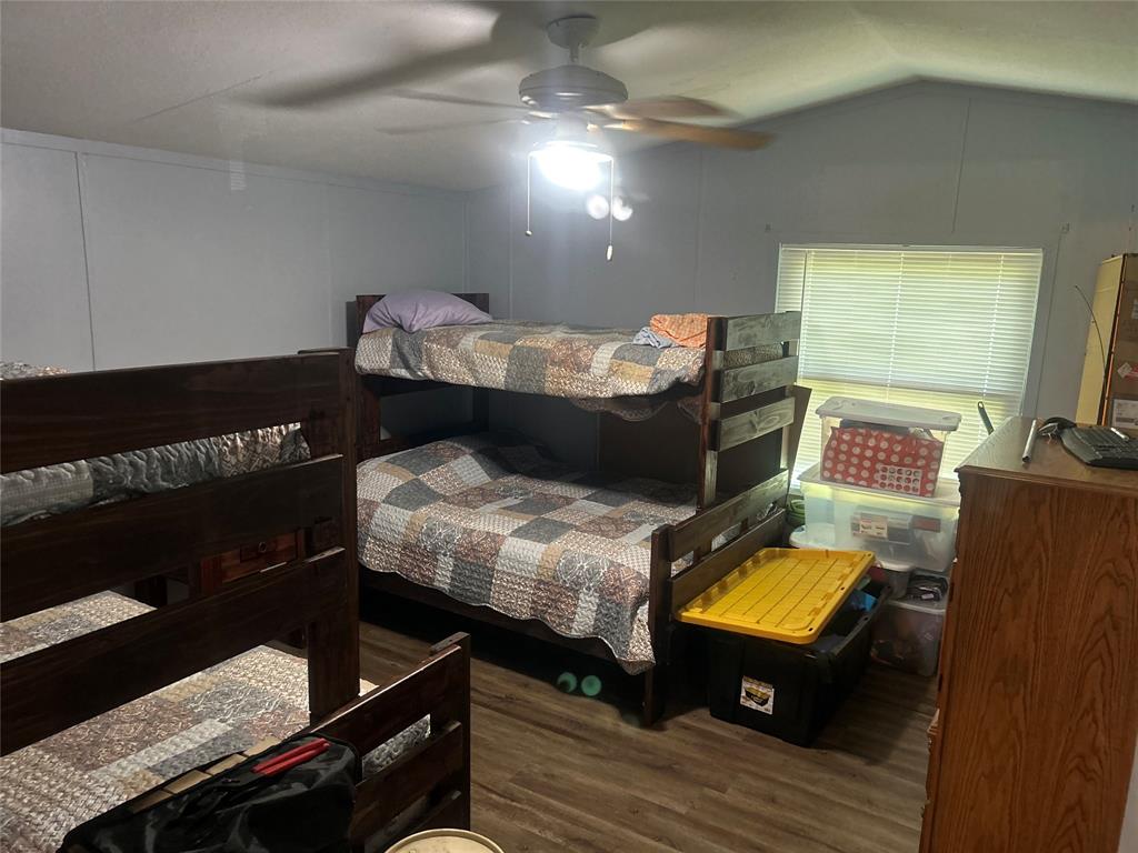 4705 Fox Hollow Road Graham, TX 76450 - Photo 18 of 28 a living room with furniture and a flat screen tv