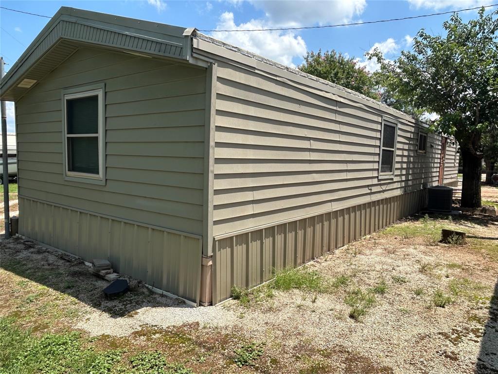 4705 Fox Hollow Road Graham, TX 76450 - Photo 3 of 28 a side view of a house with a backyard