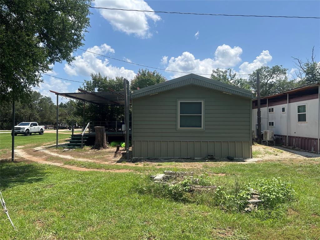 4705 Fox Hollow Road Graham, TX 76450 - Photo 4 of 28 a view of a house with backyard and a tree