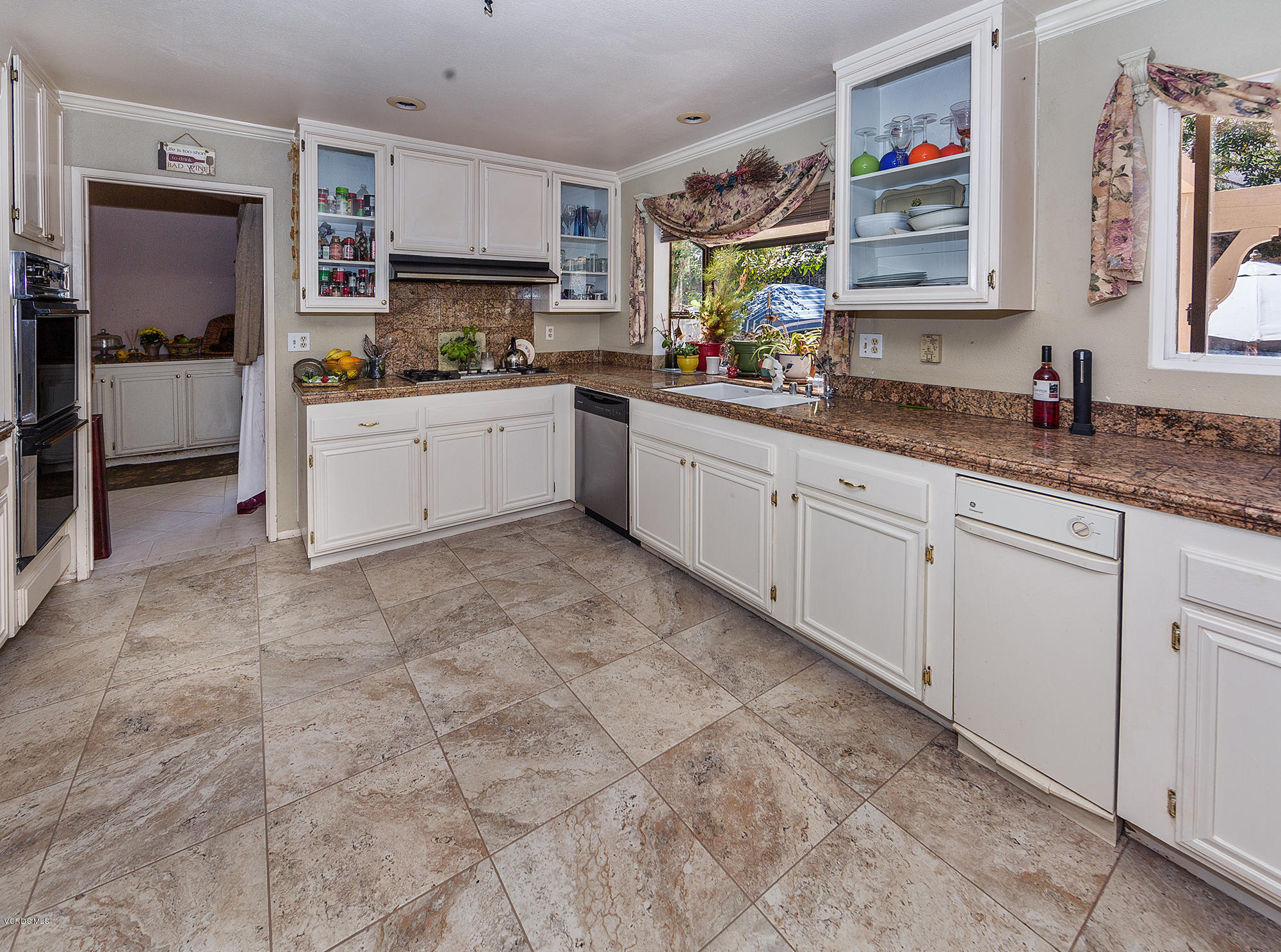12590 Crystal Ranch Road Moorpark, CA 93021 - Photo 4 of 21 a kitchen with cabinets and window