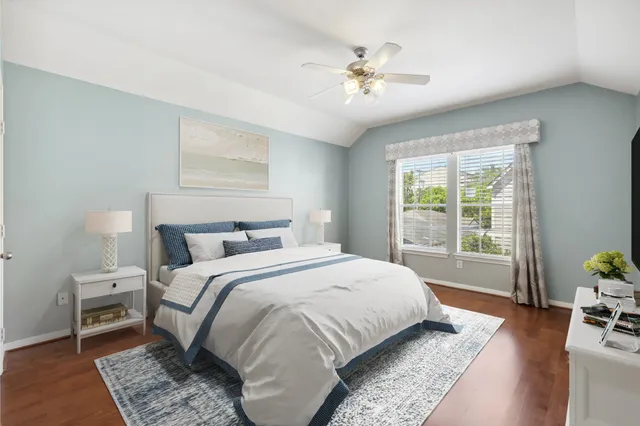 a bedroom with a bed a chandelier and a window