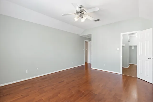 a view of an empty room with a fan