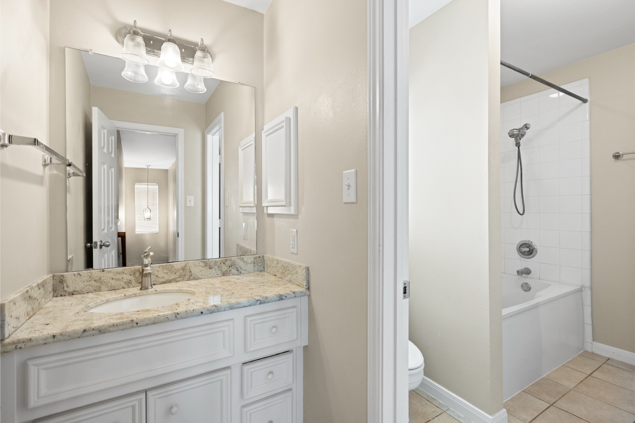 1708 Dennis Street Houston, TX 77004 - Photo 14 of 20 a bathroom with a granite countertop sink and a mirror