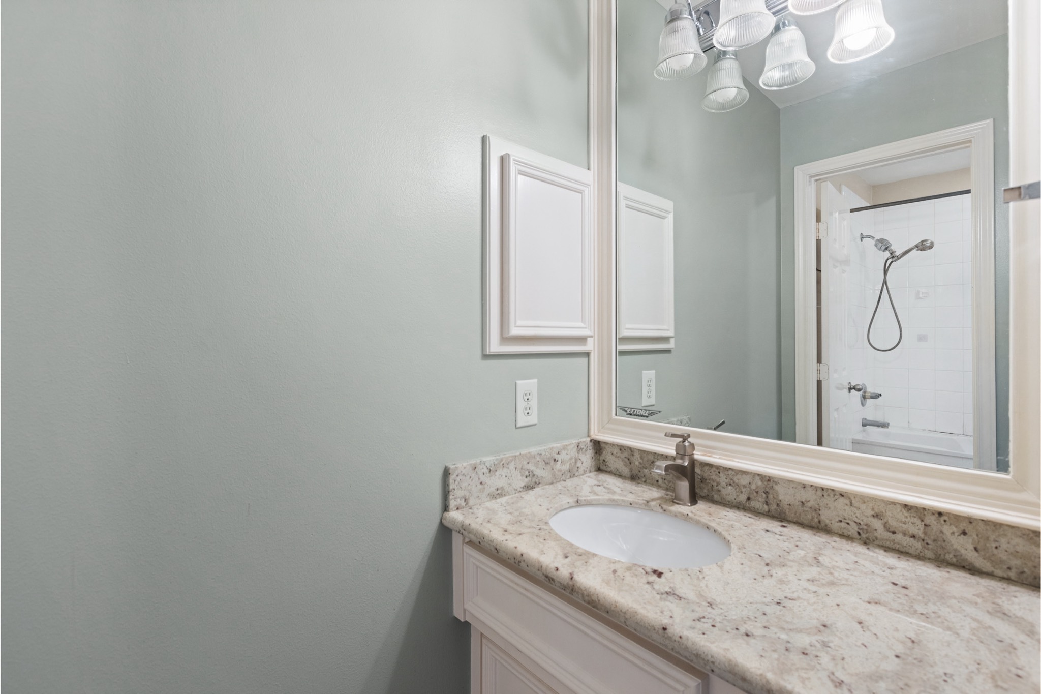 1708 Dennis Street Houston, TX 77004 - Photo 15 of 20 a bathroom with a granite countertop sink a mirror and a vanity
