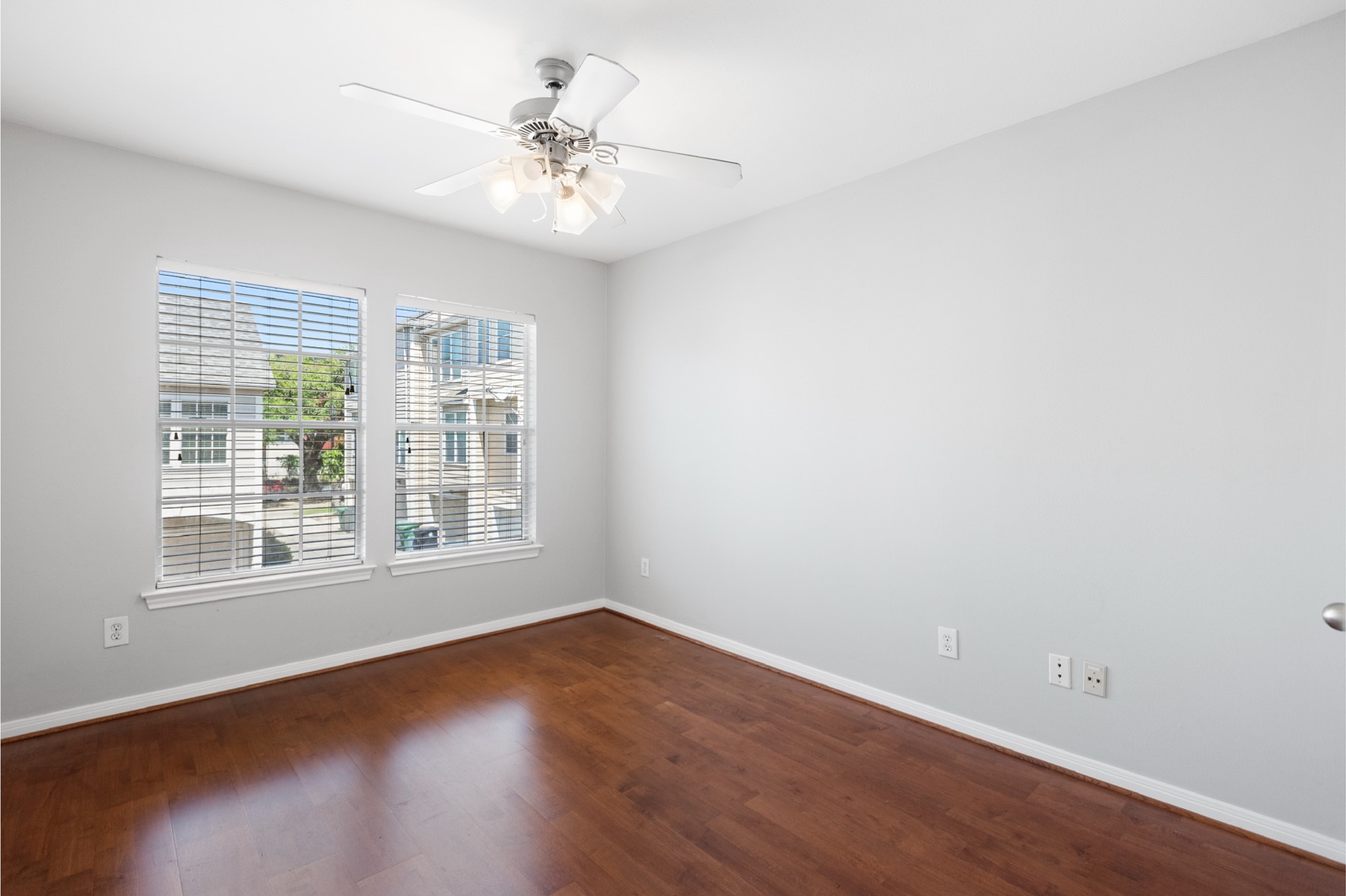 1708 Dennis Street Houston, TX 77004 - Photo 17 of 20 an empty room with wooden floor and windows