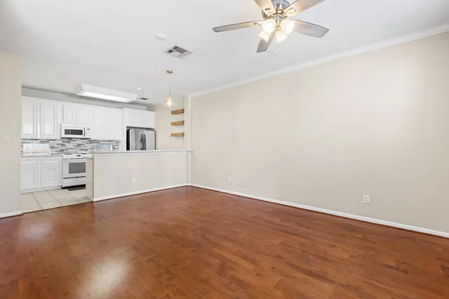 a view of a kitchen with a dishwasher cabinets and wooden floor