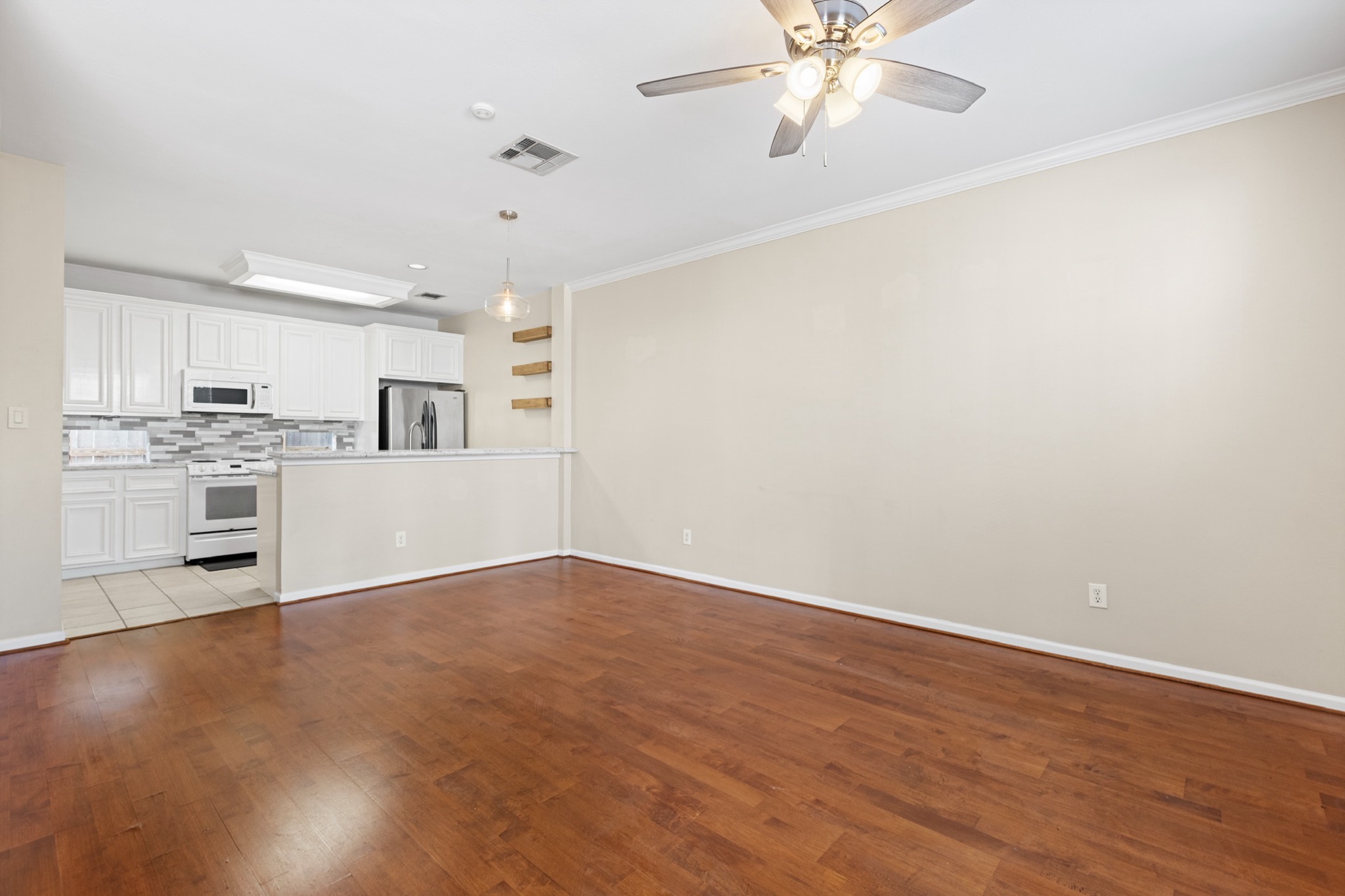 1708 Dennis Street Houston, TX 77004 - Photo 4 of 20 a view of a kitchen with a dishwasher cabinets and wooden floor