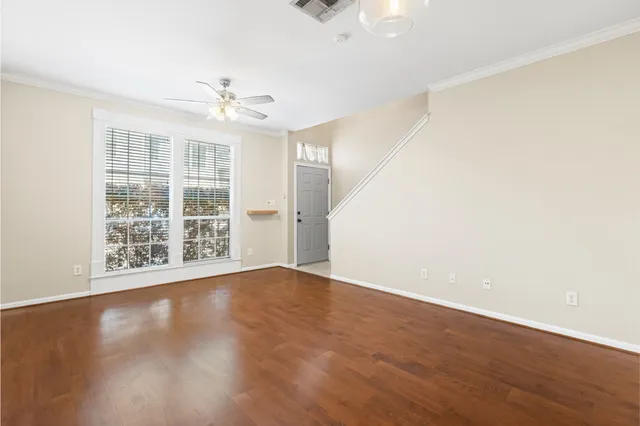 wooden floor in an empty room with a window