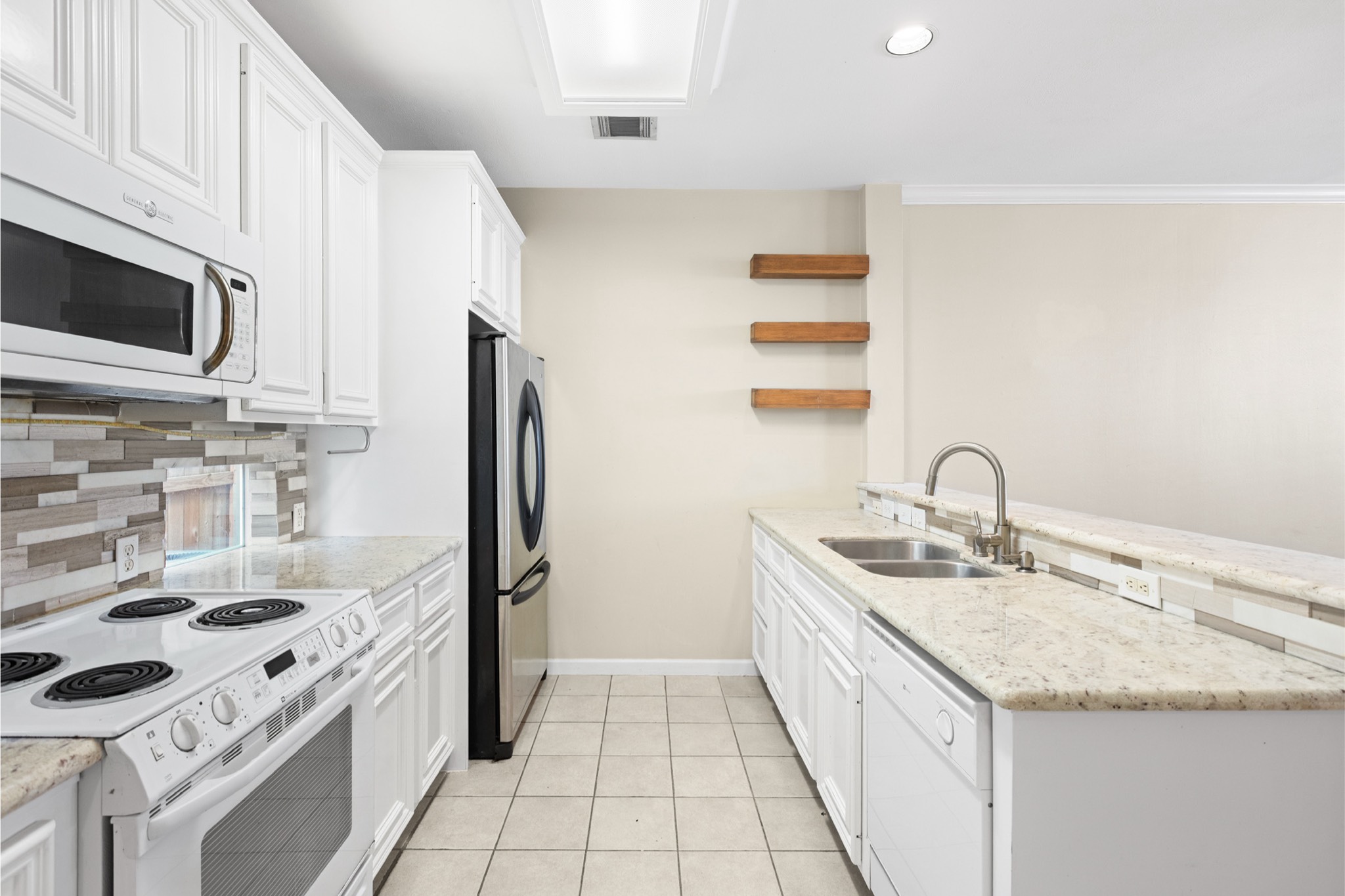 1708 Dennis Street Houston, TX 77004 - Photo 7 of 20 a kitchen with a sink stove and microwave