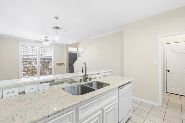 a view with granite countertop a sink and a window