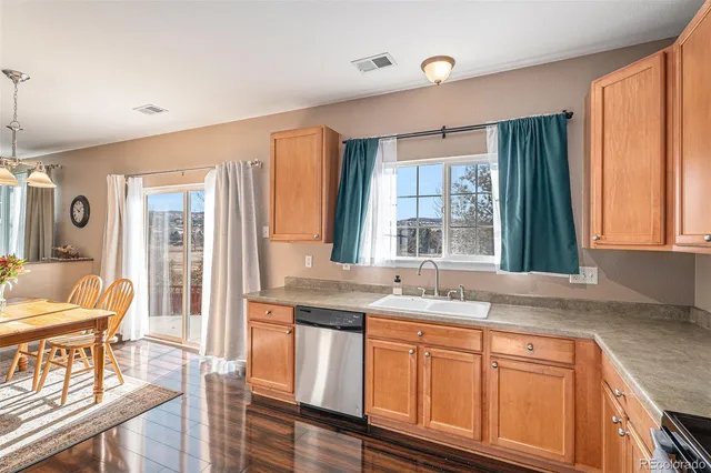 a kitchen with granite countertop a stove a sink and a cabinets