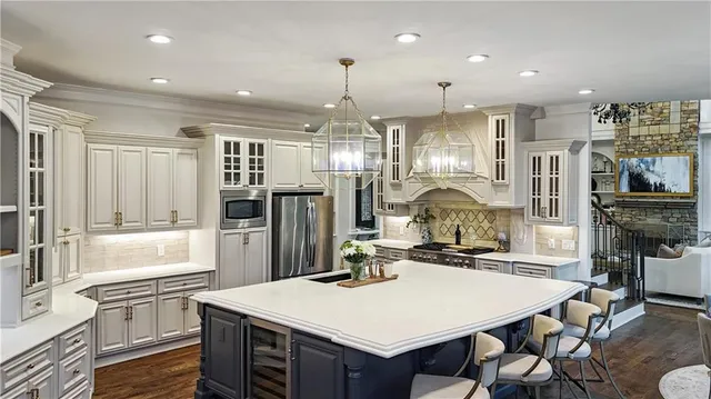 a living room with furniture a fireplace and a large window