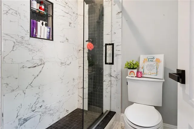 a kitchen with stainless steel appliances granite countertop a stove top oven a dining table and chairs with wooden floor