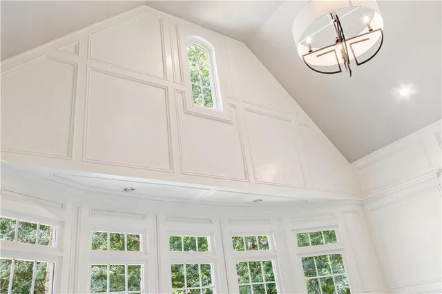a living room with couches and a dining table with wooden floor
