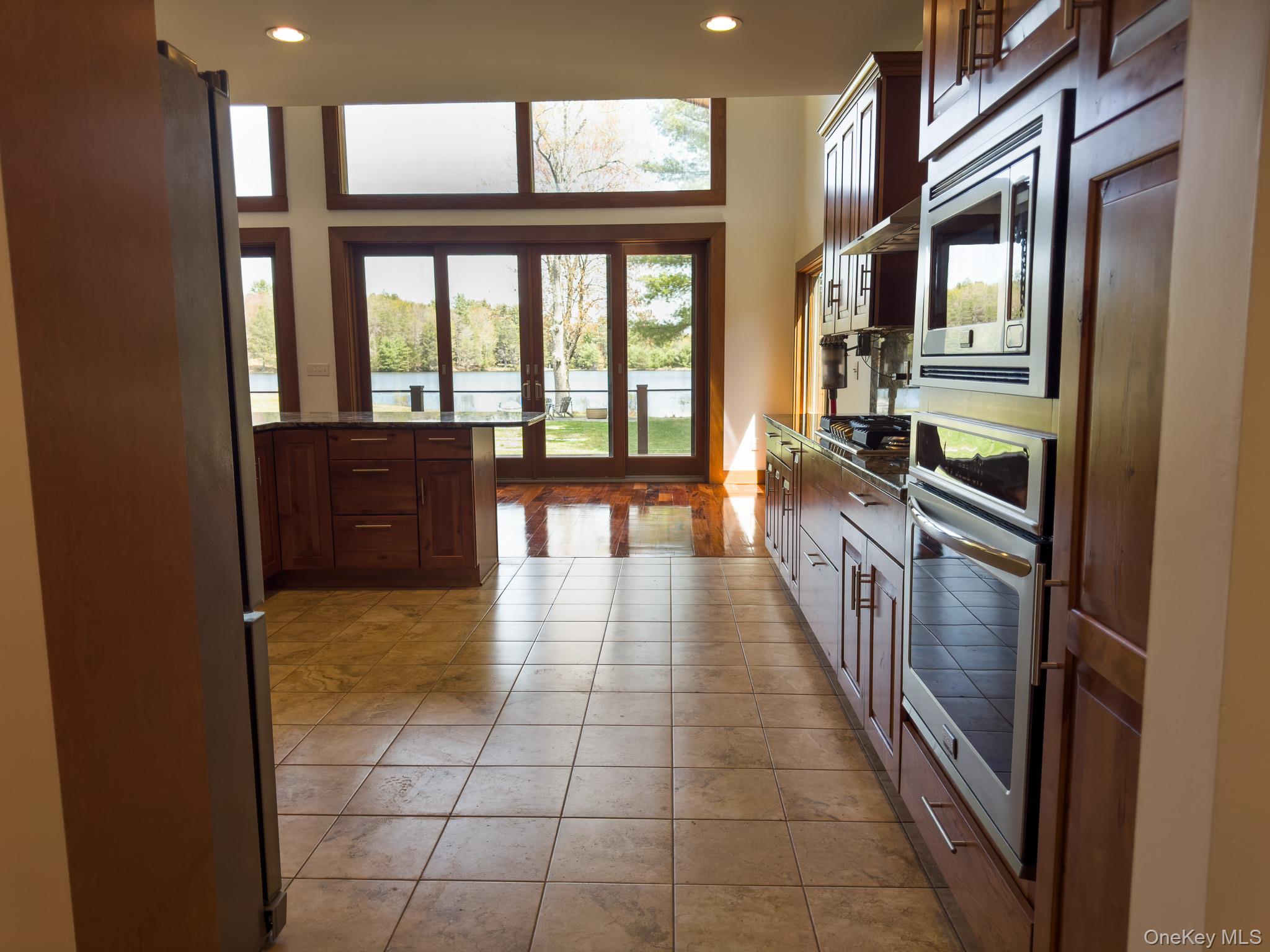 58 Deer Meadow Road Bethel, NY 12786 - Photo 10 of 29 a hallway with a large kitchen view and a refrigerator