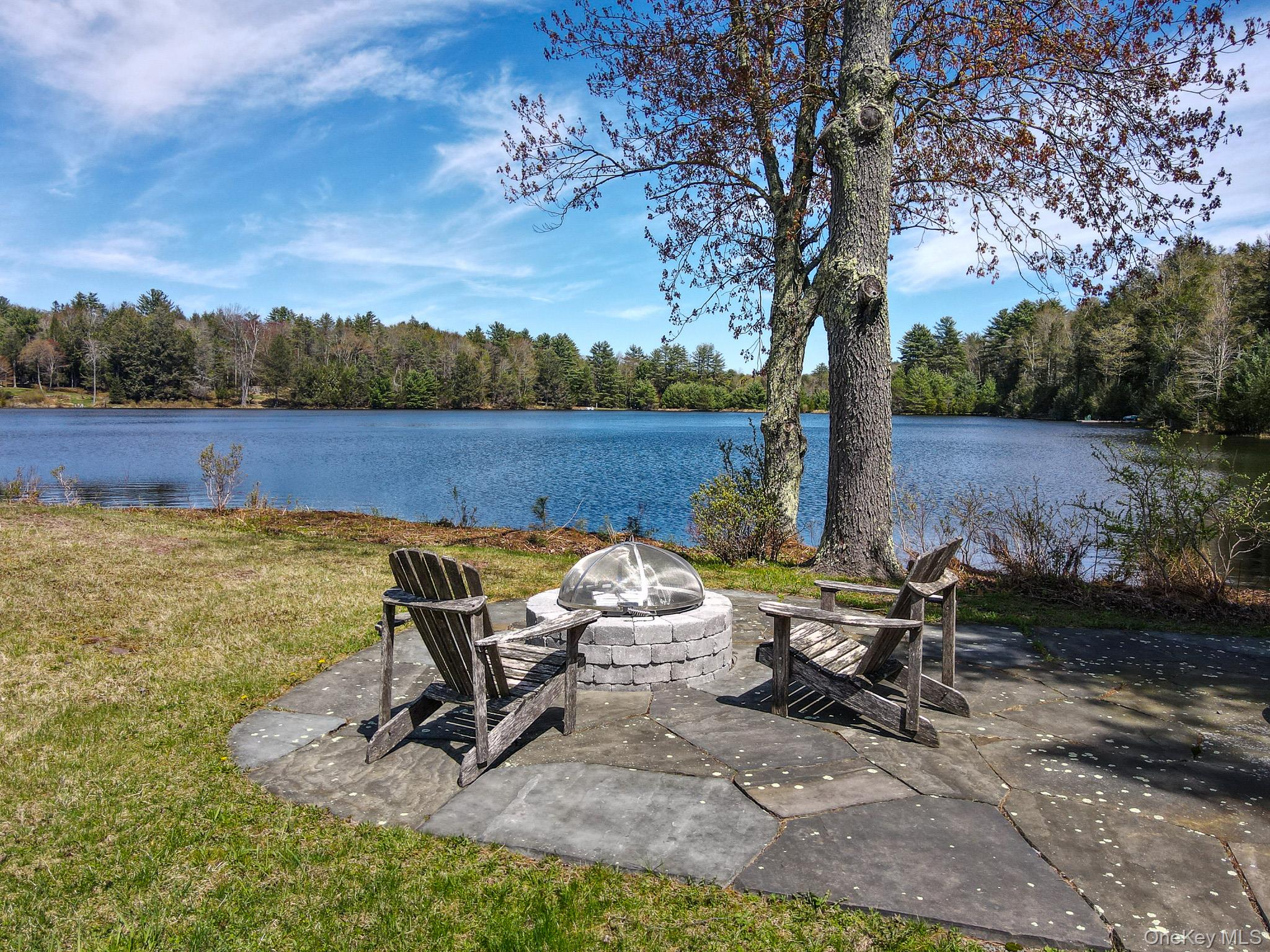 58 Deer Meadow Road Bethel, NY 12786 - Photo 15 of 29 a view of a lake with outdoor seating and trees