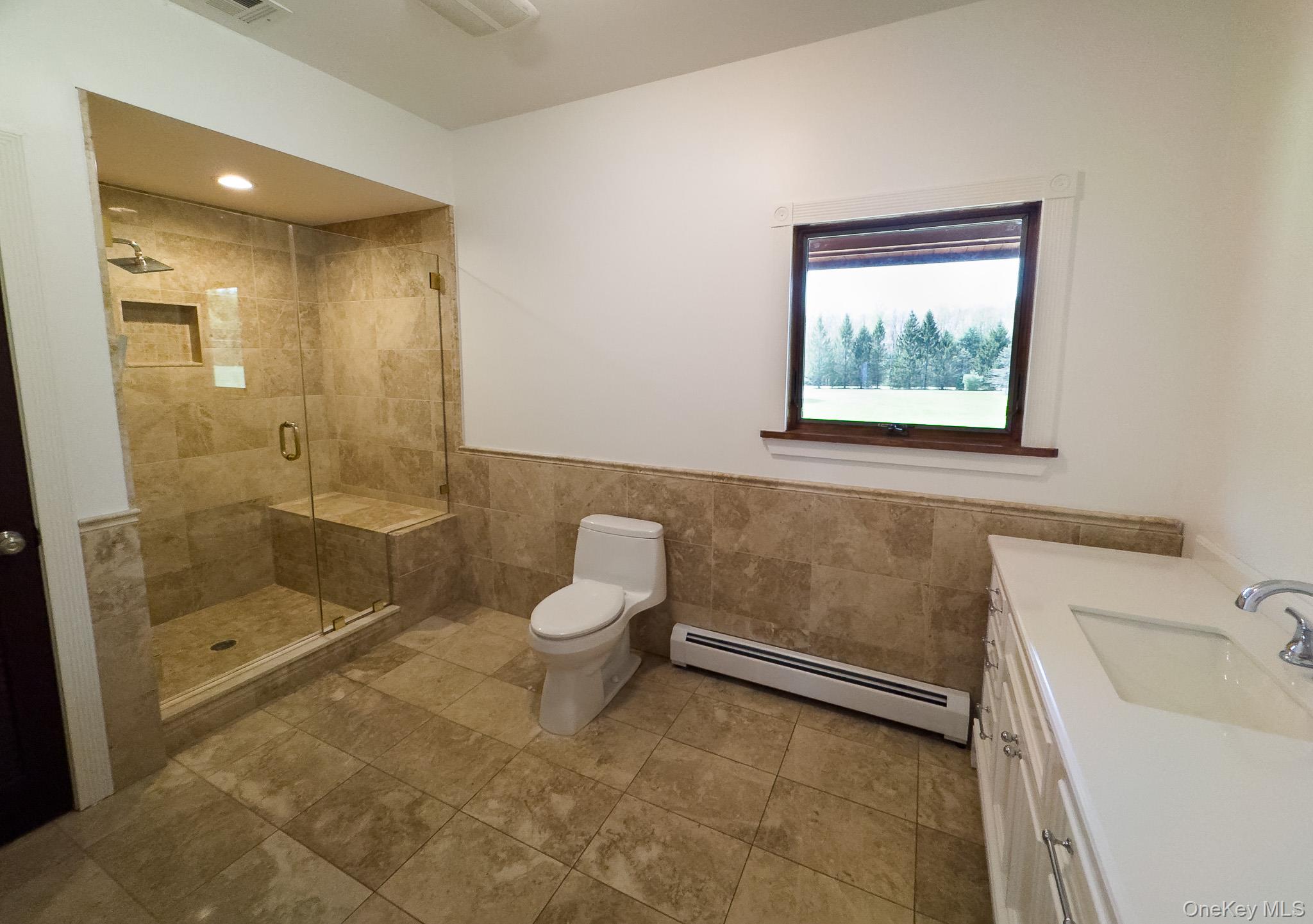 58 Deer Meadow Road Bethel, NY 12786 - Photo 24 of 29 a bathroom with a toilet sink and shower