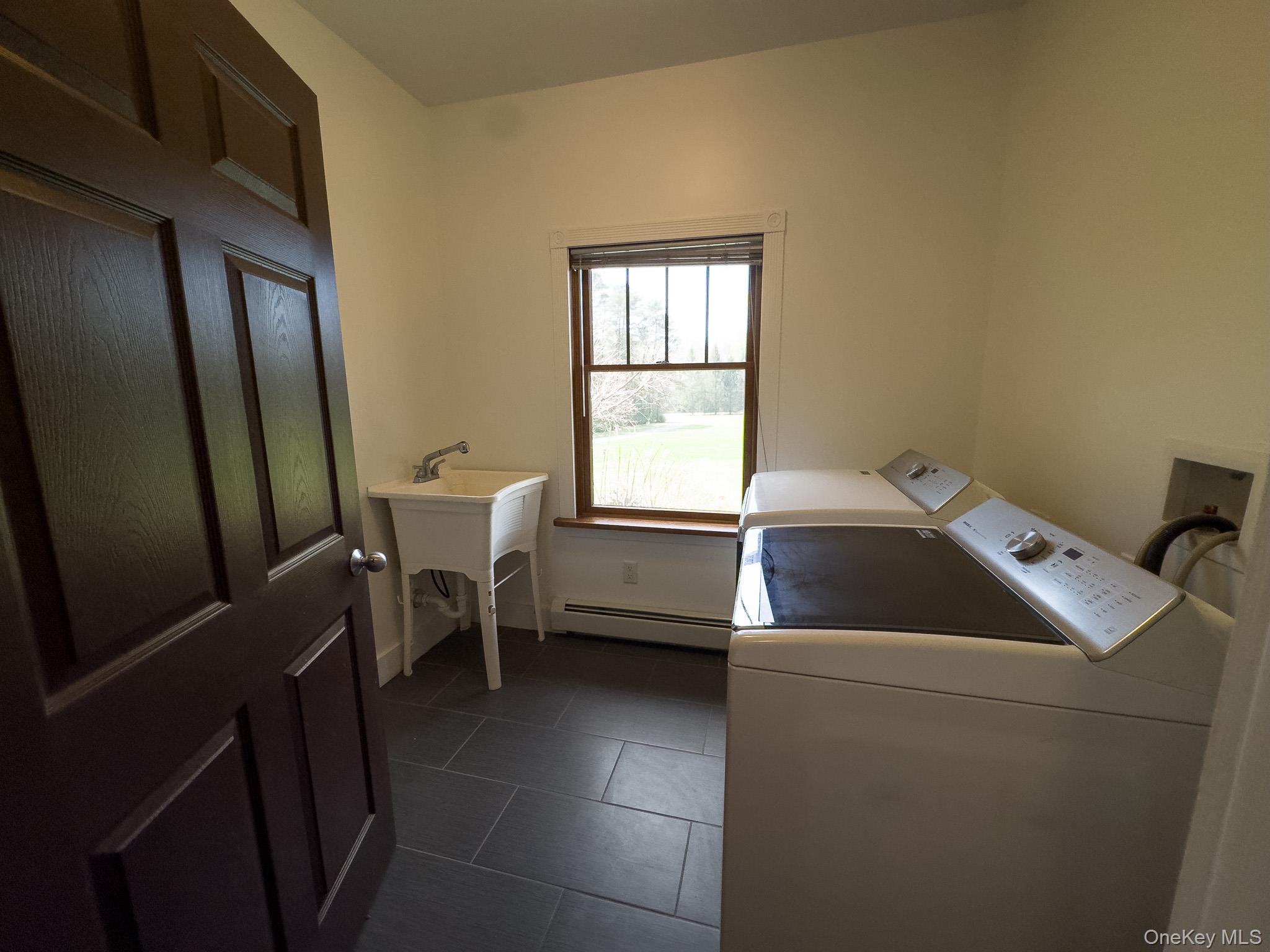 58 Deer Meadow Road Bethel, NY 12786 - Photo 25 of 29 a room with a chair and washer