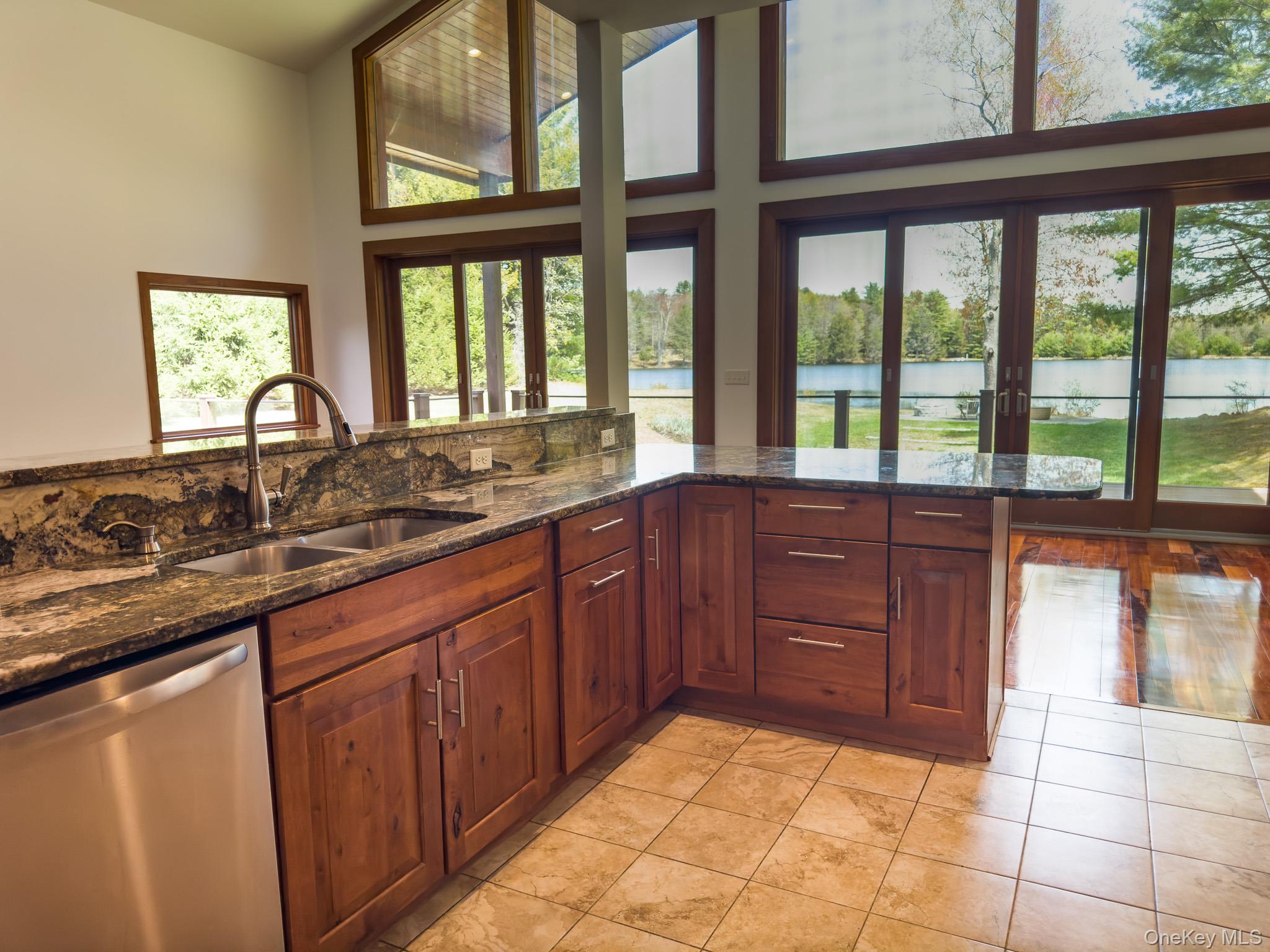 58 Deer Meadow Road Bethel, NY 12786 - Photo 6 of 29 a large kitchen with granite countertop a sink and a large window