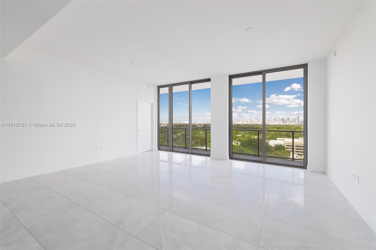 2678 Tigertail Avenue, Unit 1104 Miami, FL 33133 - Photo 20 of 65 an empty room with floor to ceiling window