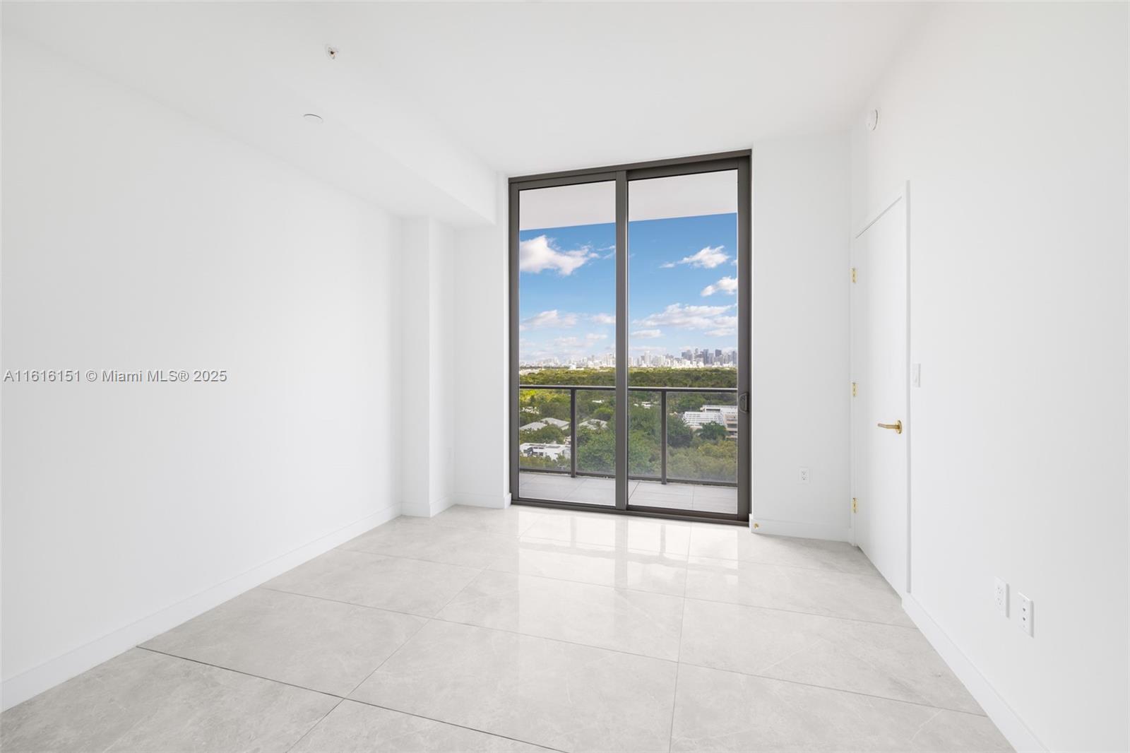 2678 Tigertail Avenue, Unit 1104 Miami, FL 33133 - Photo 23 of 65 an empty room with sliding glass door and shower