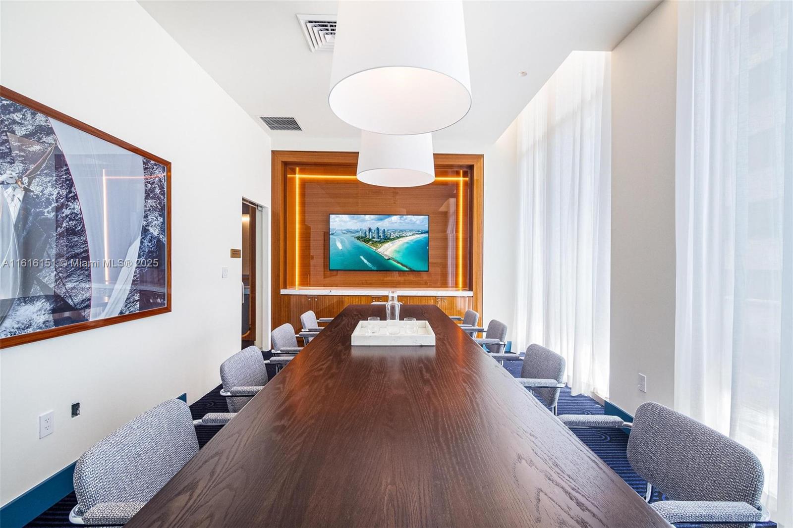 2678 Tigertail Avenue, Unit 1104 Miami, FL 33133 - Photo 42 of 65 a living room with furniture and a chandelier