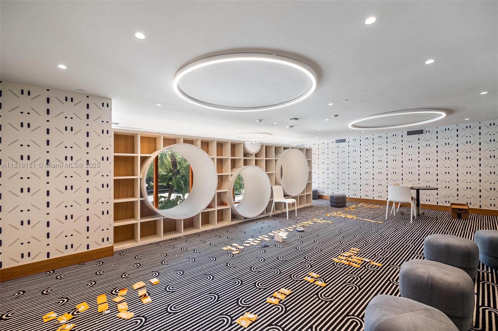 2678 Tigertail Avenue, Unit 1104 Miami, FL 33133 - Photo 61 of 65 a living room with furniture a rug and a window