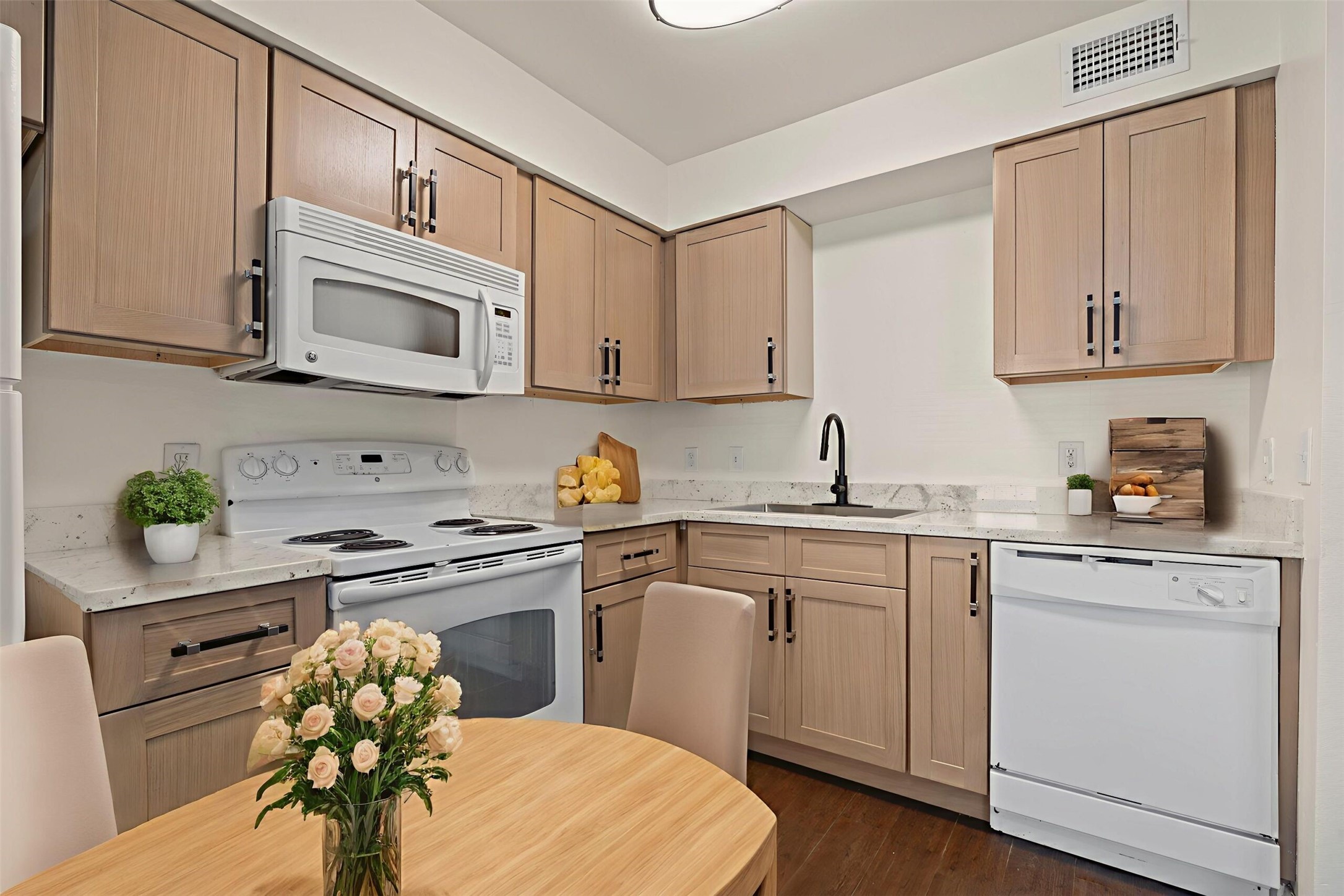 8210 Bauman Road, Unit 40 Houston, TX 77022 - Photo 2 of 10 a kitchen with stainless steel appliances a sink a stove a microwave and cabinets
