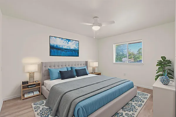 a bedroom with bed and paintings on the wall