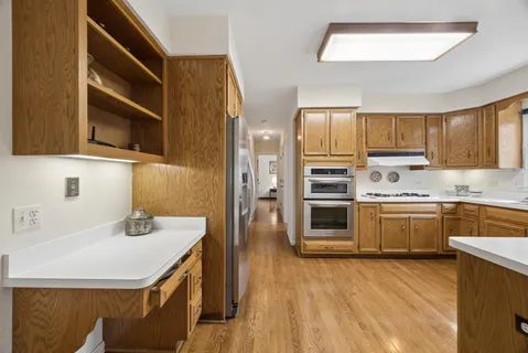 a kitchen with a sink cabinets and stainless steel appliances