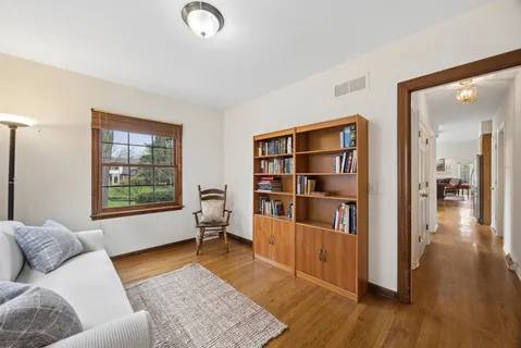 a living room with furniture and a book shelf