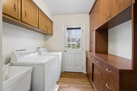 a utility room with sink dryer and washer
