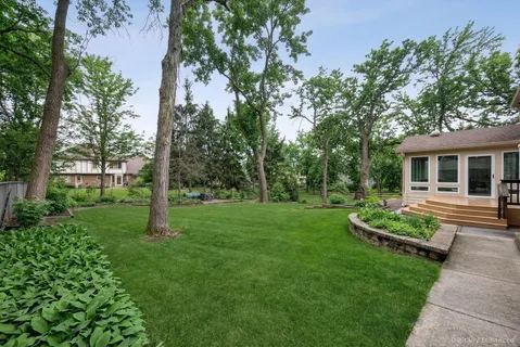 a view of a house with backyard sitting area and garden