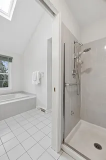 a bathroom with a tub and a shower