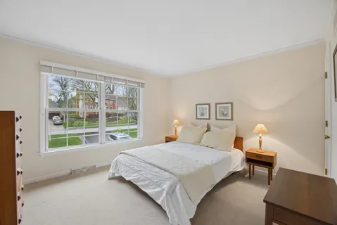 a bedroom with a large bed and a window