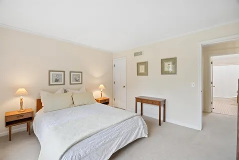 a bedroom with a bed and lamps