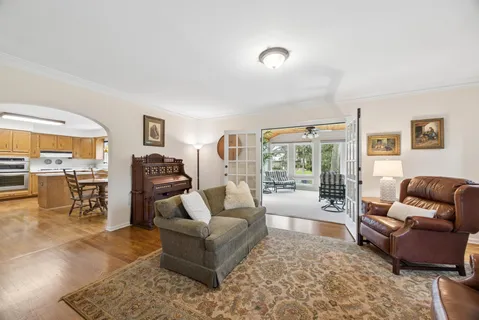 a living room with furniture and a floor to ceiling window