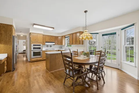 a view of a dining room with furniture window and wooden floor