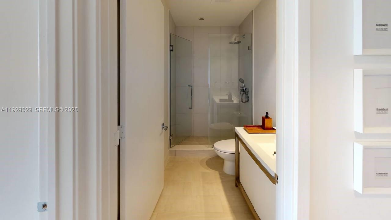 2000 Metropica Way, Unit 1701 Sunrise, FL 33323 - Photo 11 of 32 a bathroom with a tub and shower