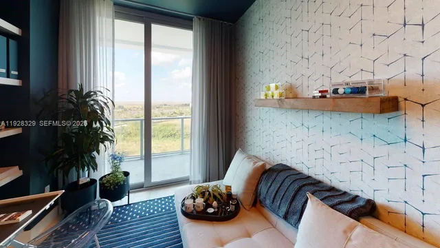 a bedroom with bed and a large window