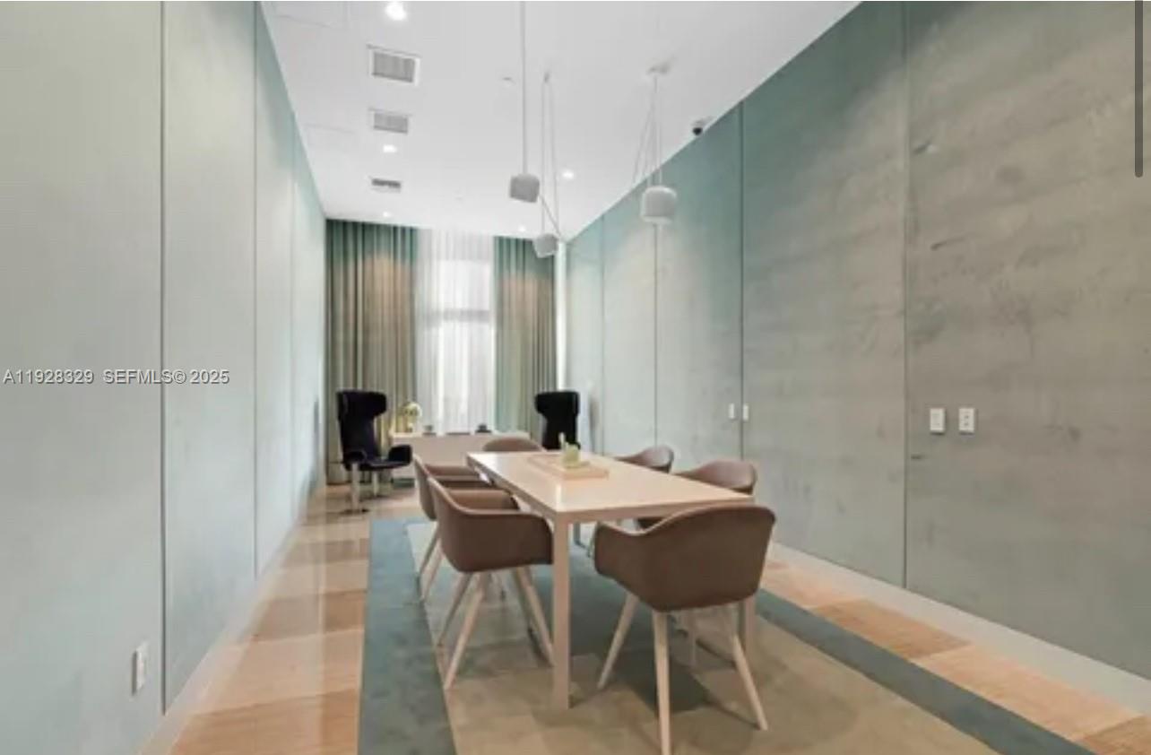 2000 Metropica Way, Unit 1701 Sunrise, FL 33323 - Photo 16 of 32 a view of a dining room with furniture and wooden floor