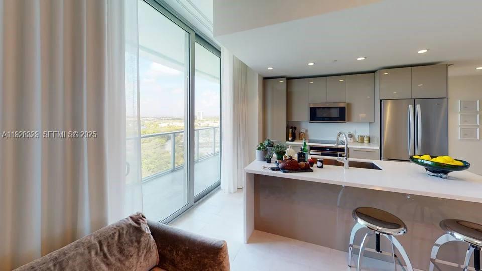 2000 Metropica Way, Unit 1701 Sunrise, FL 33323 - Photo 3 of 32 a kitchen with a sink appliances and a counter top space