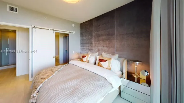 a bedroom with a bed and a walk in closet