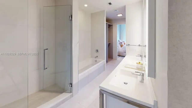 a bathroom with a bathtub and a shower