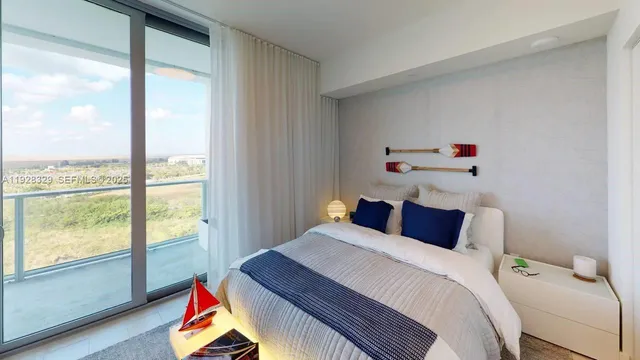 a bedroom with a bed and a large window with outer view